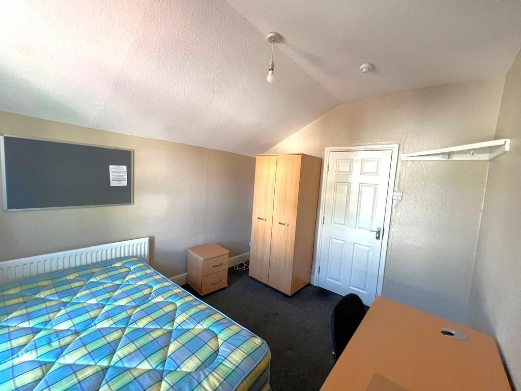 Neat furnished bedroom with a double bed, wardr...