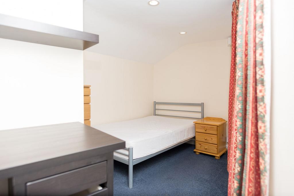 Bright, tidy bedroom with a metal single bed, b...