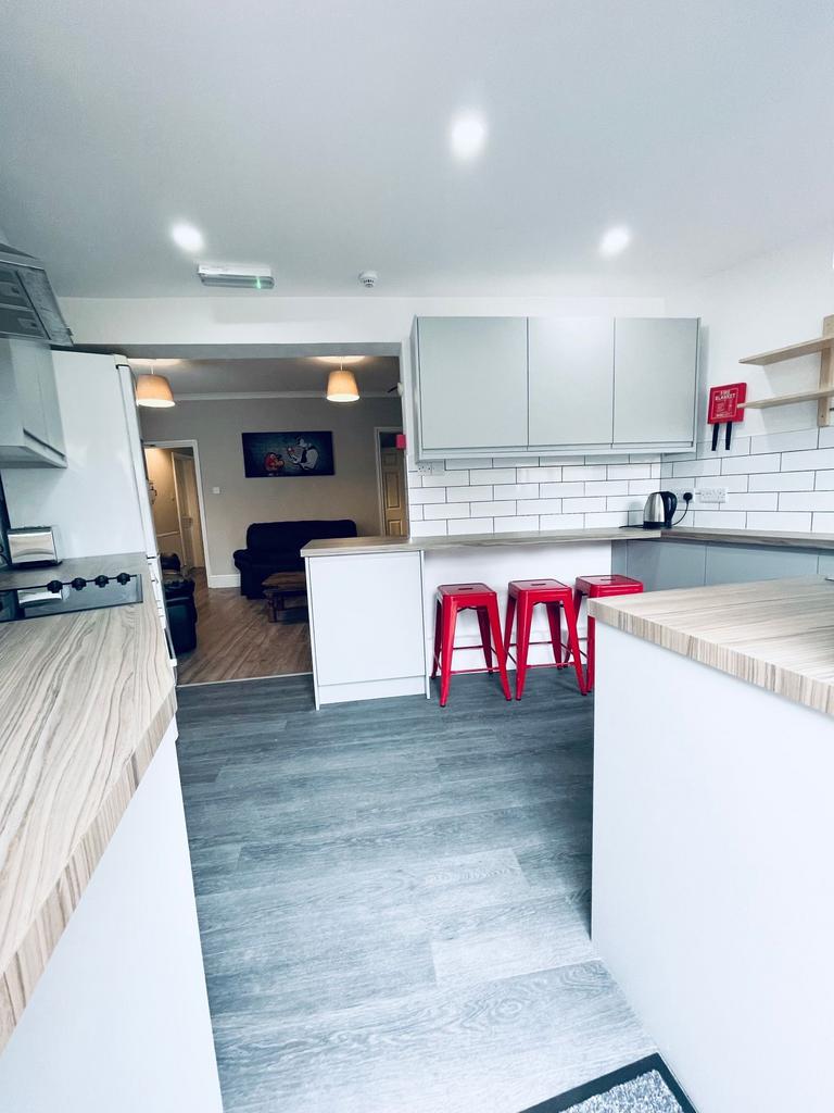 Bright modern kitchen with light wood-effect wo...
