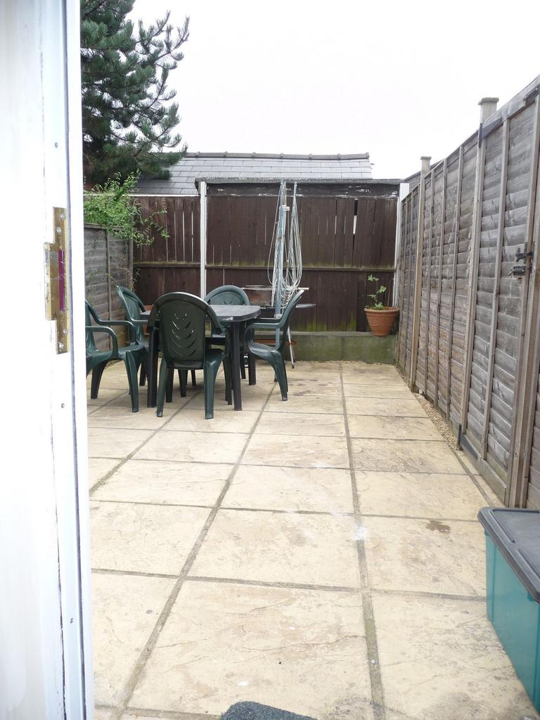 Low-maintenance paved rear garden with a centra...