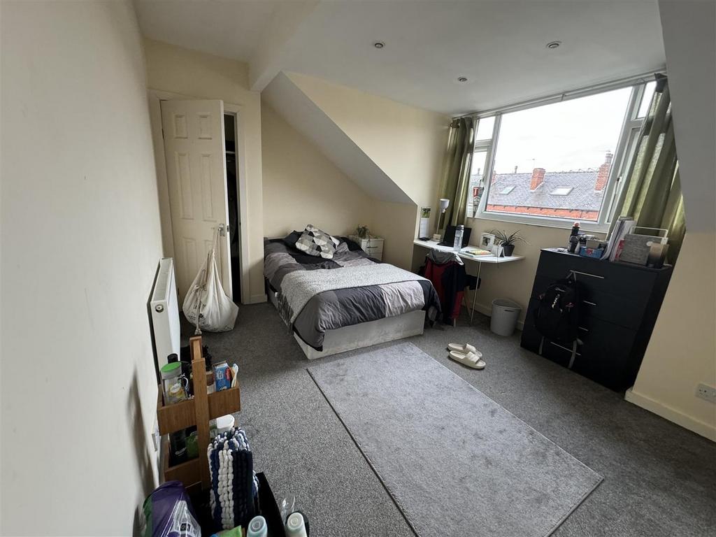 Bright and inviting bedroom with large window a...