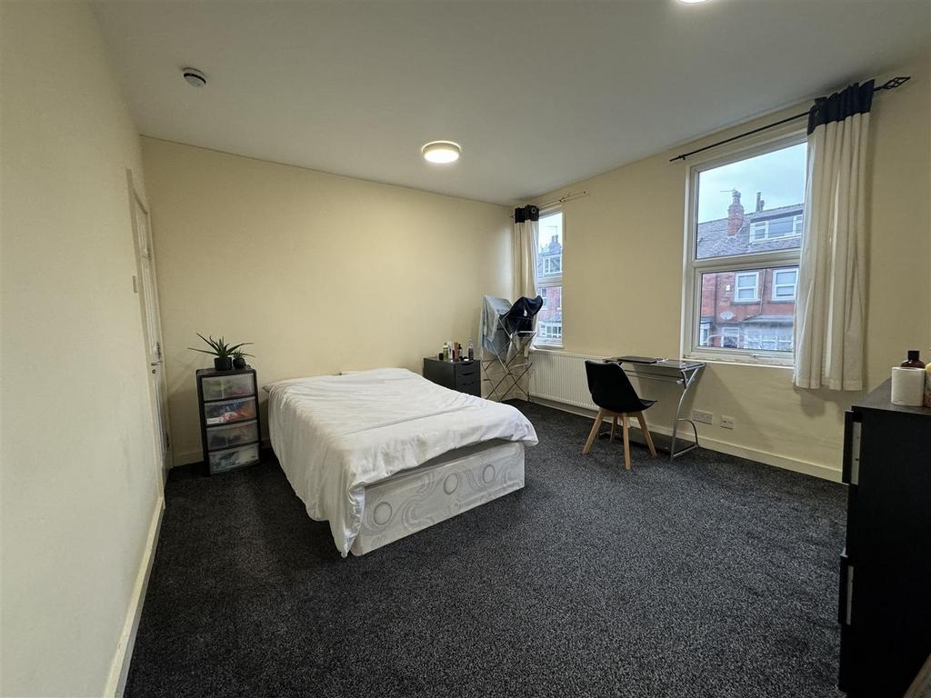 Bright and spacious living room with large wind...