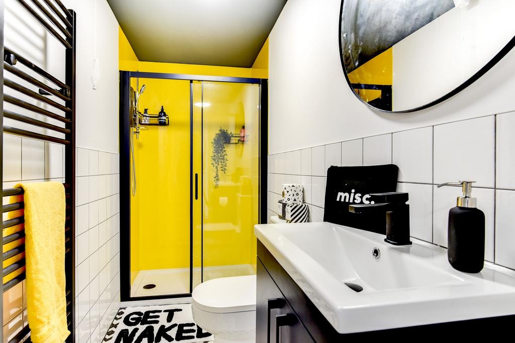 This stylish bathroom features a modern design ...