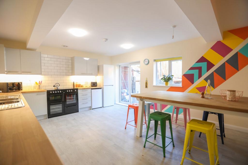 Bright and modern kitchen featuring white cabin...