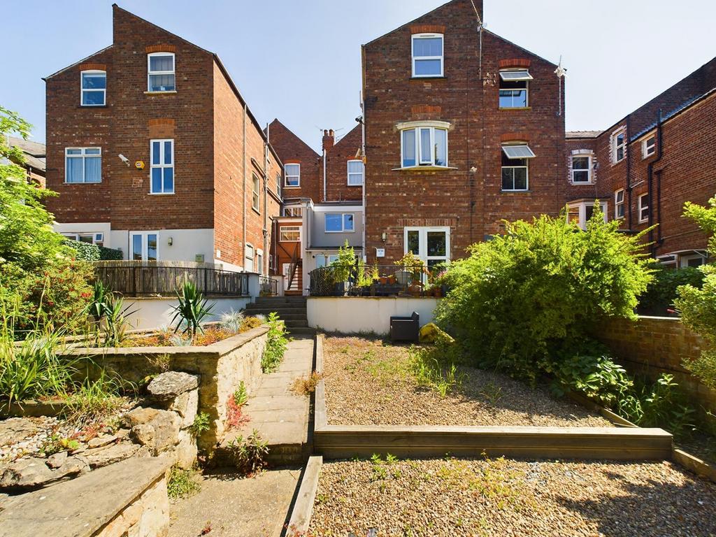 Well-kept communal garden with terraced beds, p...