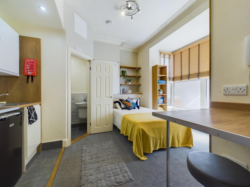 Compact open-plan studio with a fitted kitchene...