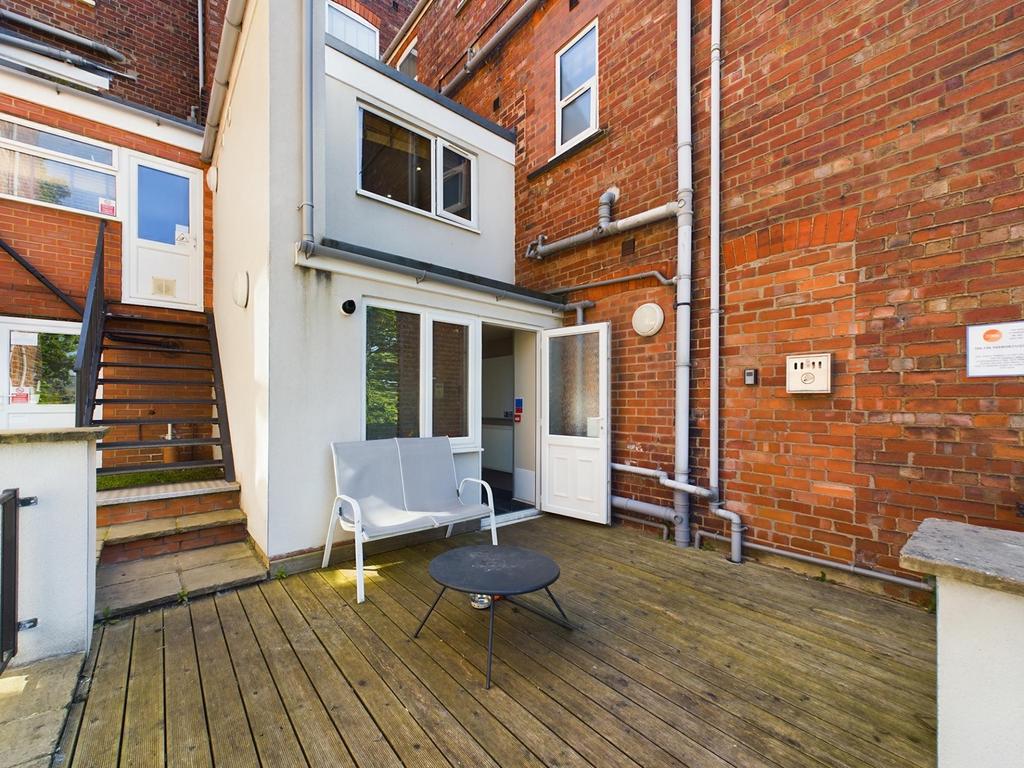 Private paved courtyard with seating area and d...