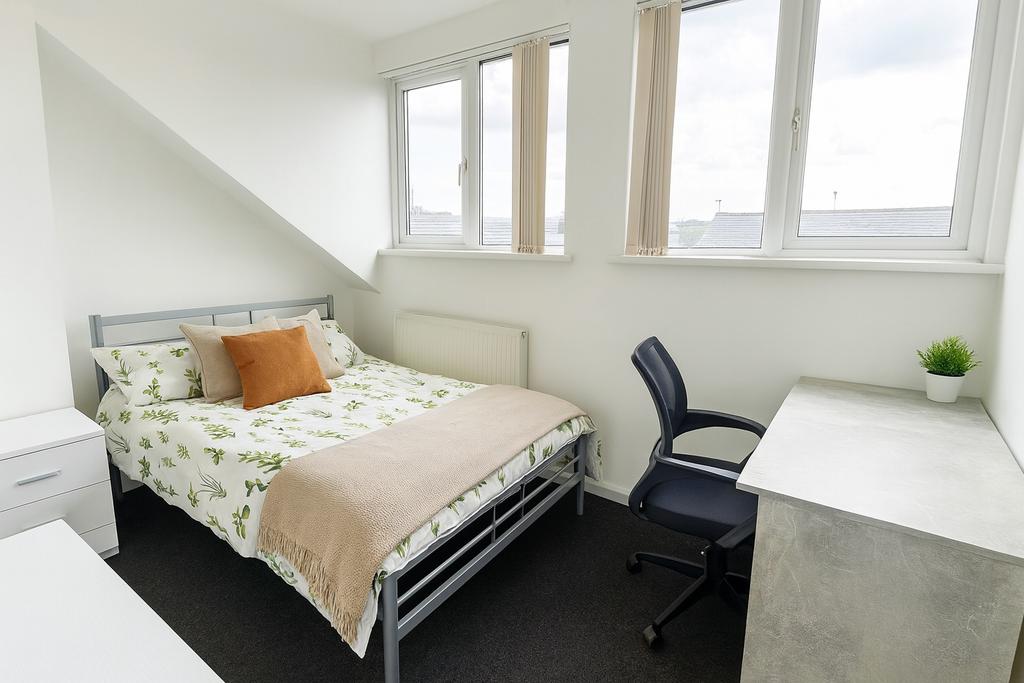 Bright and welcoming bedroom featuring a double...