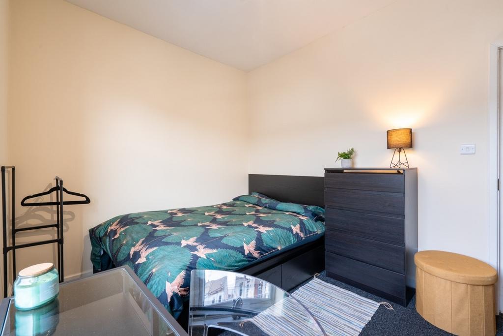 Bright, neatly presented bedroom with a pattern...
