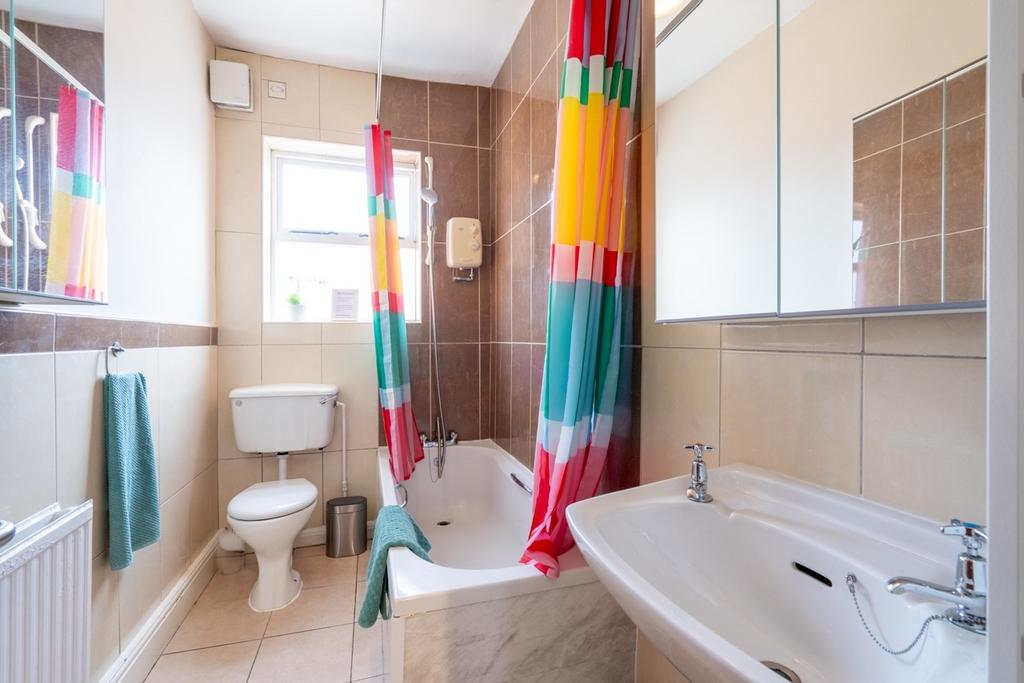 Bright, well-kept bathroom with a bathtub and o...