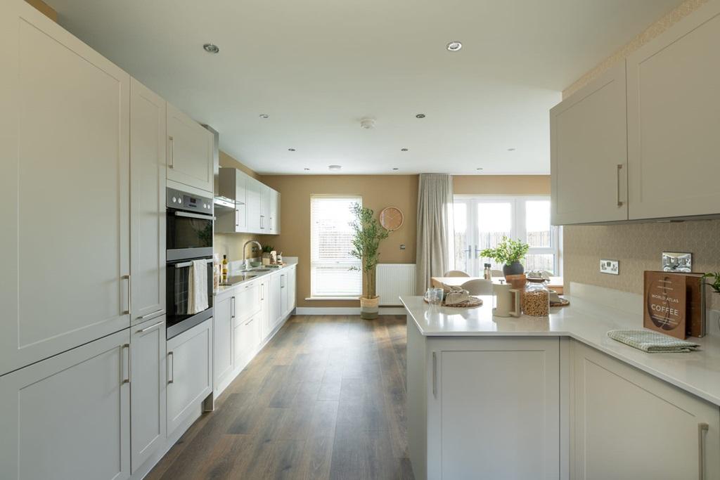 A modern kitchen area with ample storage