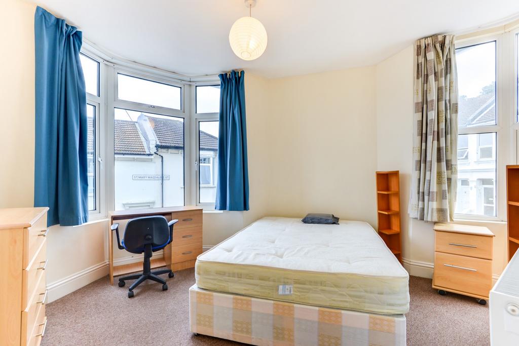 Bright double bedroom with a central double bed...