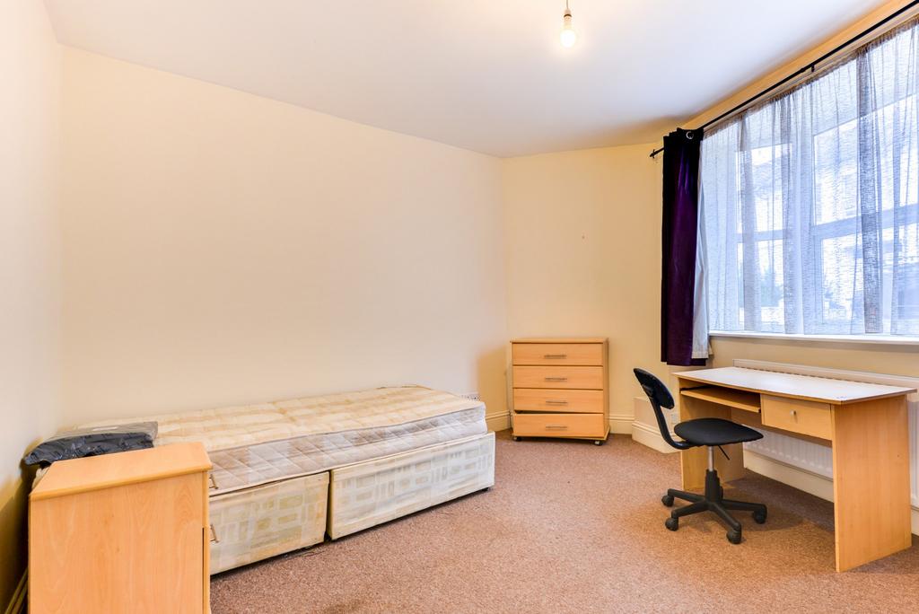 Bright, simply furnished bedroom with a large w...