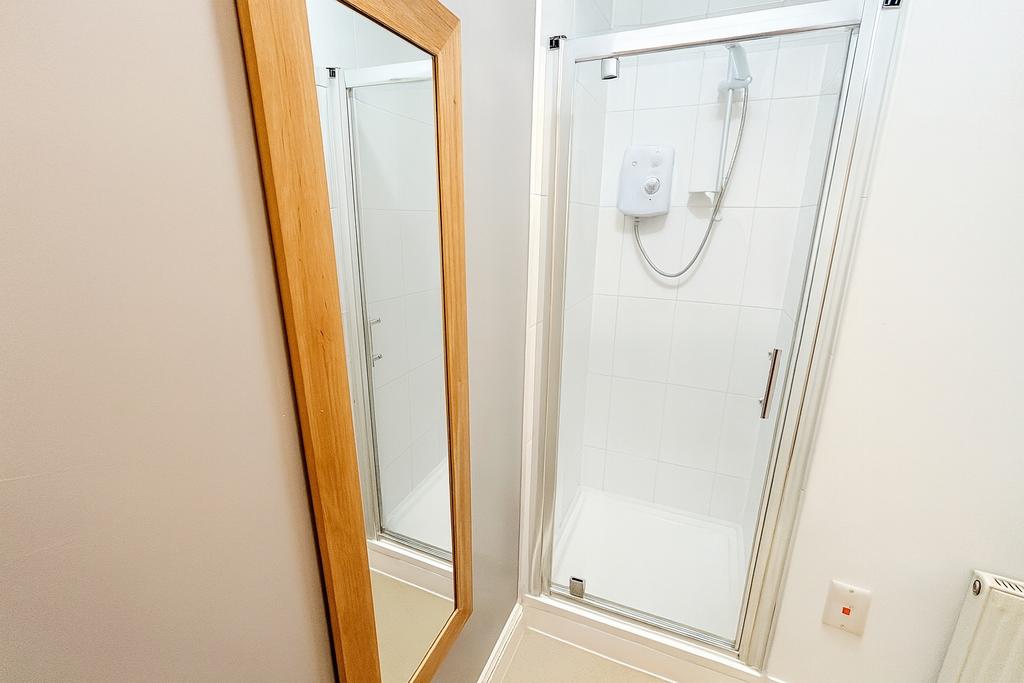 Bright, modern shower cubicle with clean white ...