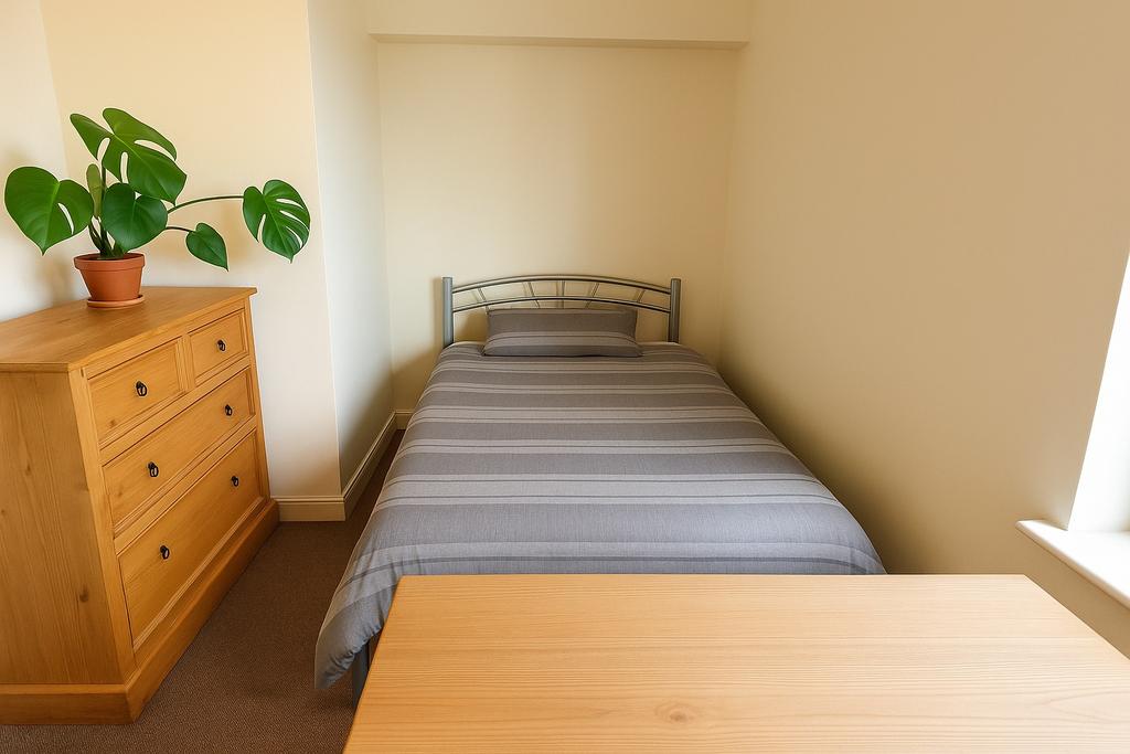 Neat, minimalist single bedroom with a striped ...
