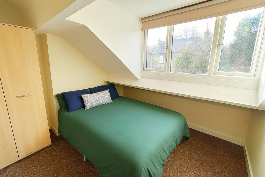 Bright double bedroom with a large dormer windo...