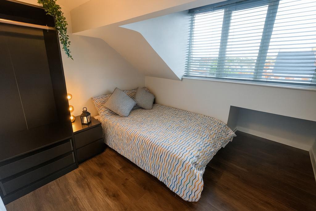 Bright, neatly styled double bedroom with a pat...