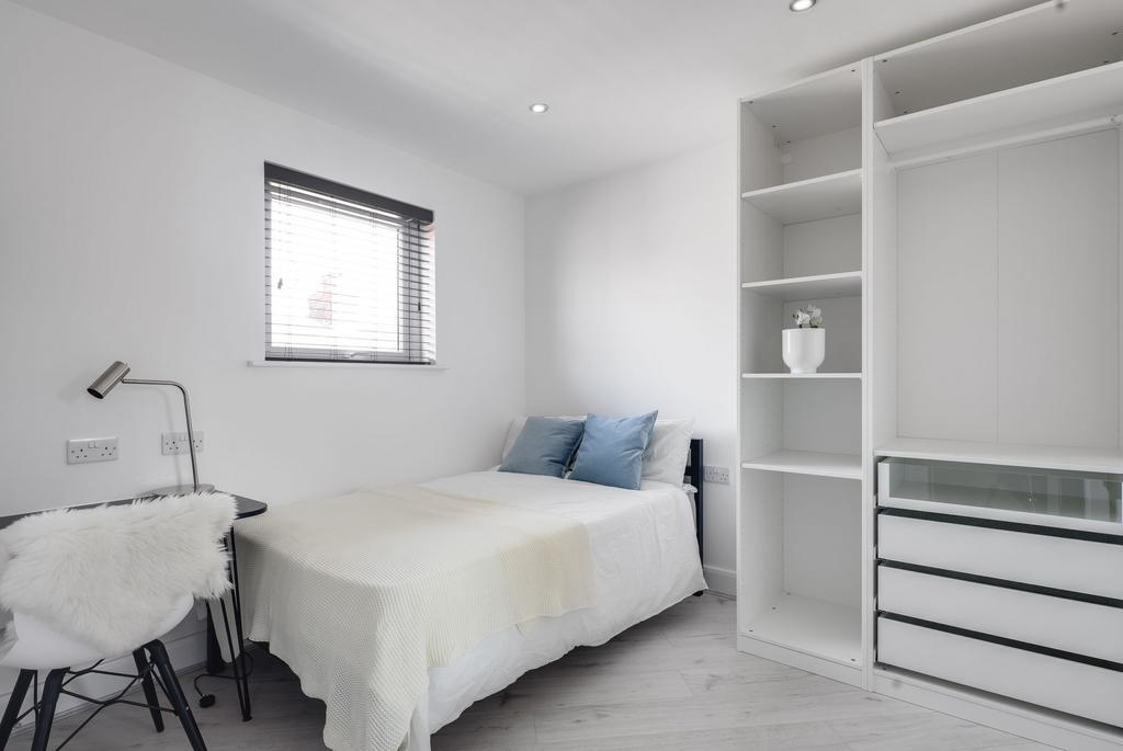 Bright and modern bedroom featuring a cozy sing...