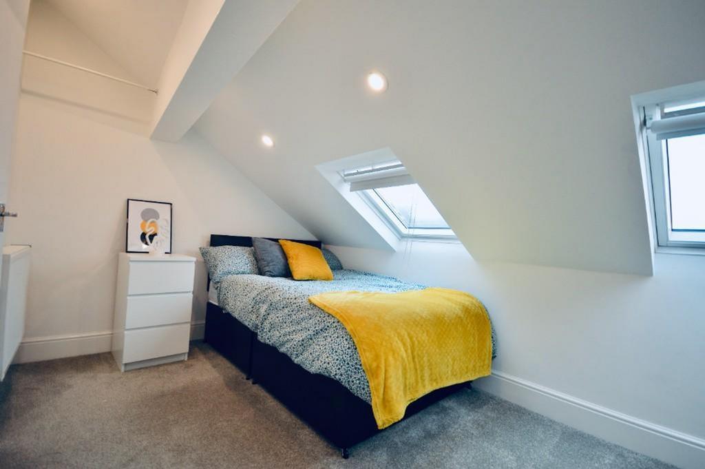 This inviting double bedroom features a cozy be...