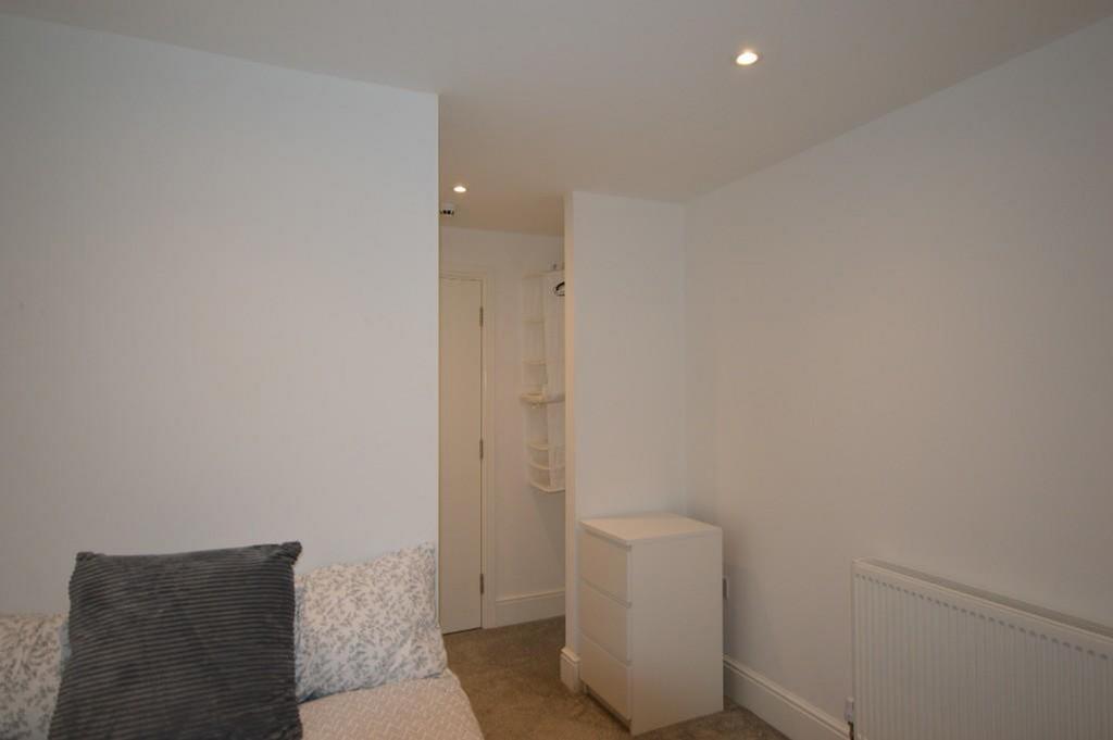 This inviting double bedroom features a cozy at...