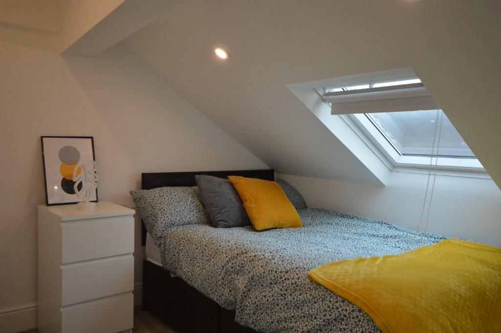 This charming double bedroom features a cozy la...