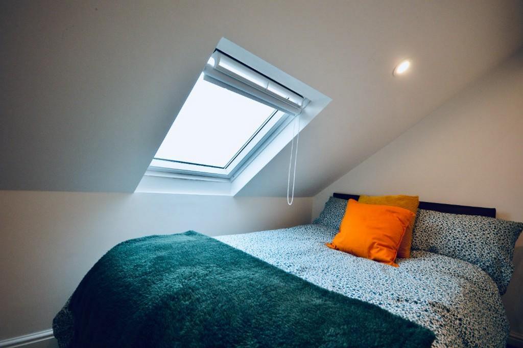 This cozy double bedroom features a comfortable...