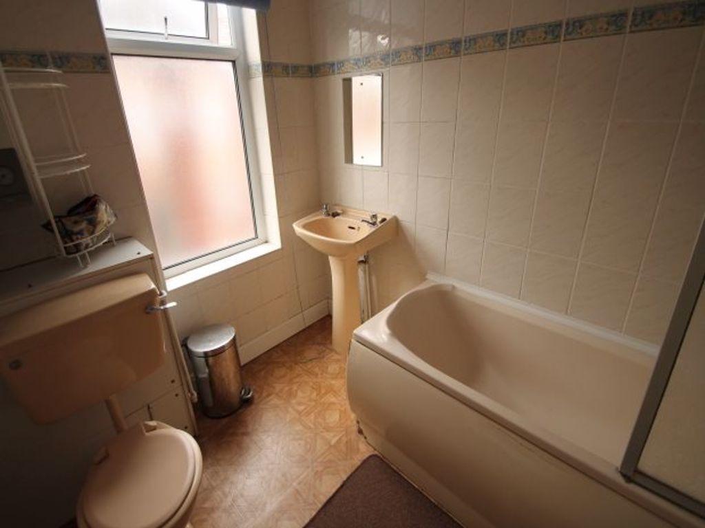 Bright, well-maintained bathroom with a bathtub...