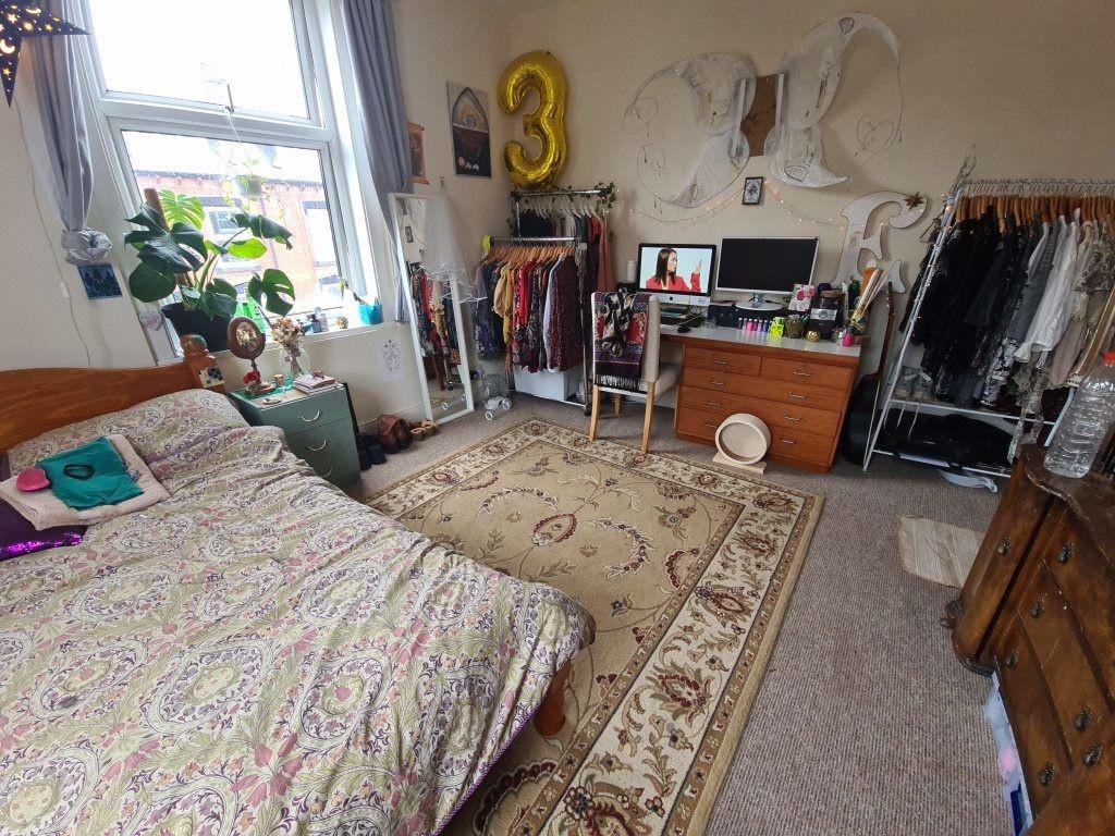 Bright, cozy double bedroom with patterned rug,...