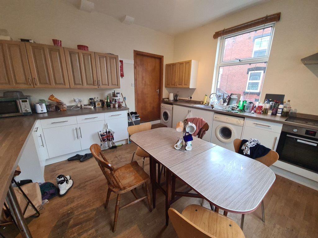 Bright, well-equipped kitchen with modern appli...