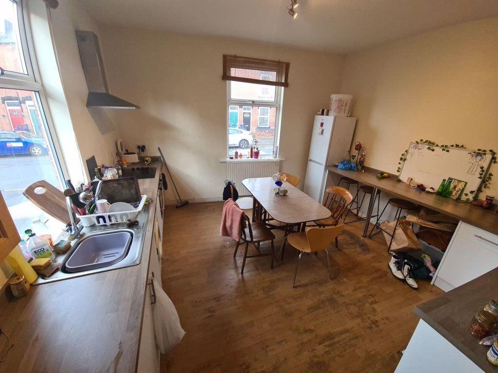 Bright, well-equipped kitchen with a long workt...