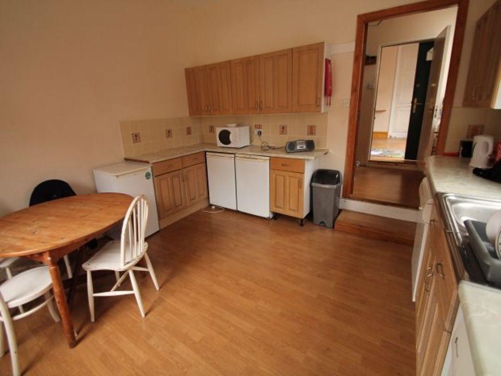 Bright kitchen with wooden cabinetry, laminate ...