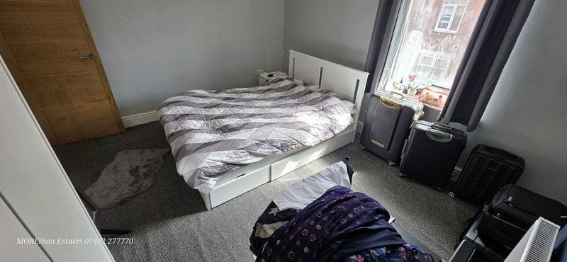 Bright double bedroom featuring a cozy double b...