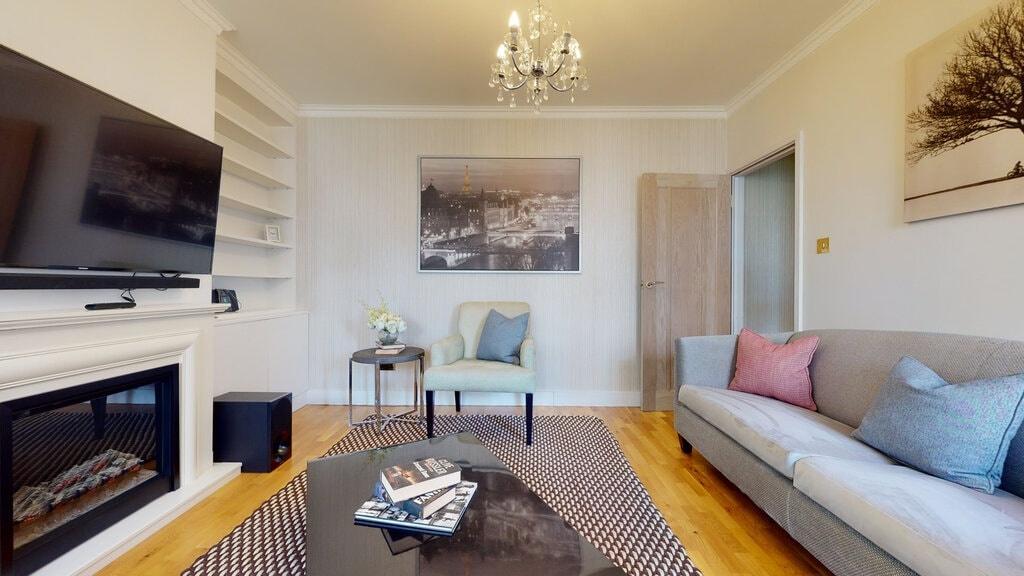 Bright, stylish living room with a wall-mounted...