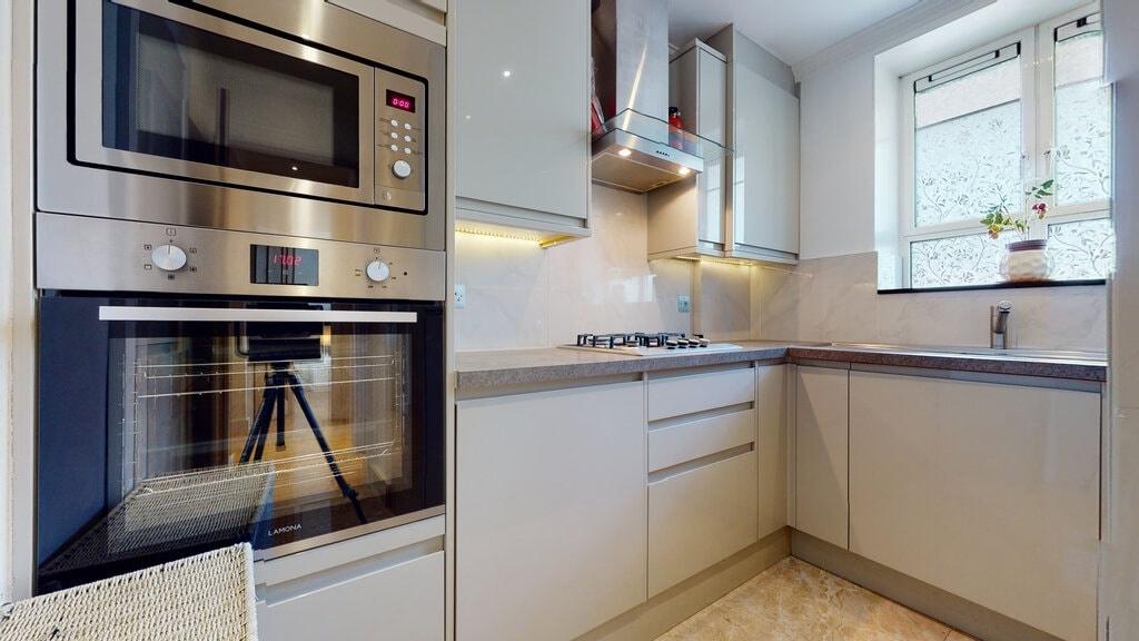 Modern fitted kitchen with integrated stainless...