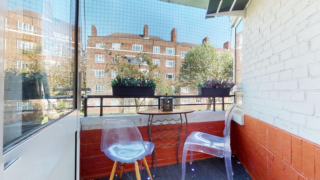Sunny private balcony with seating, planter box...