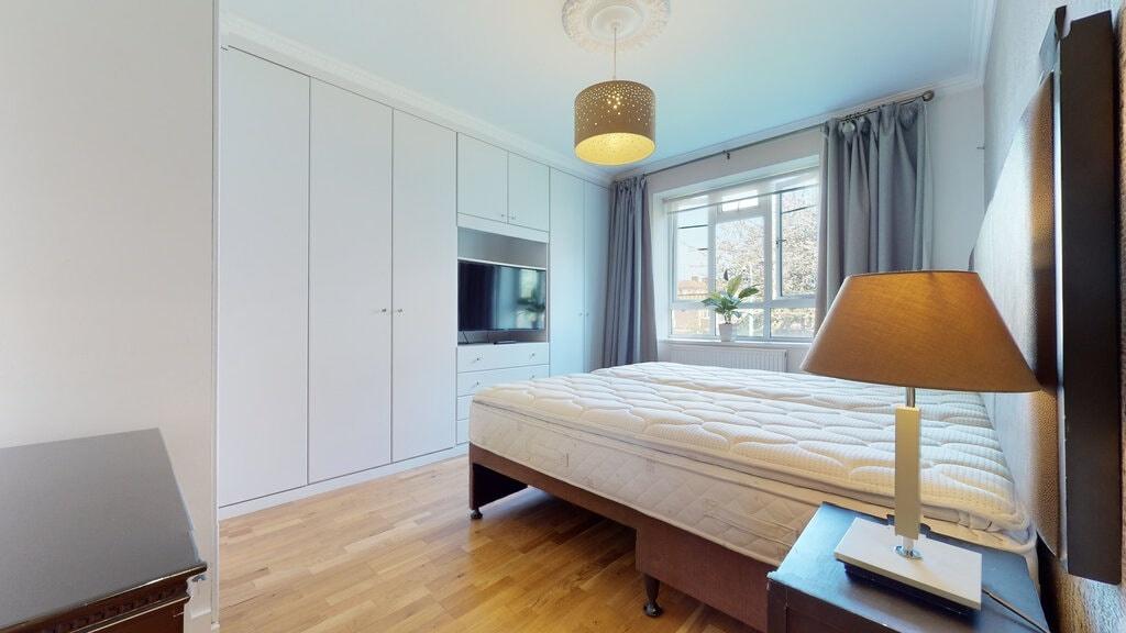Bright, well-presented master bedroom with a la...