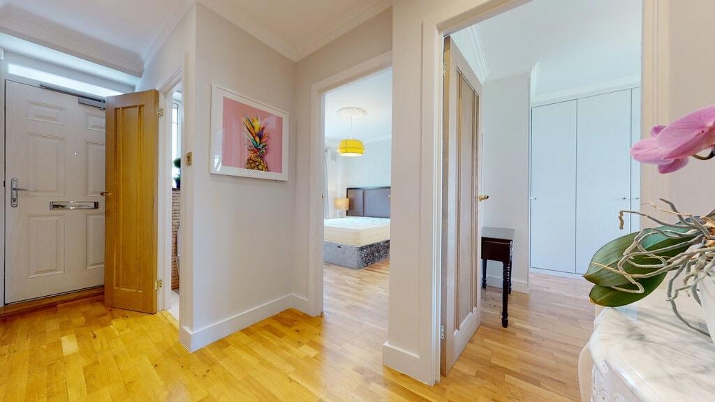 Bright, welcoming entrance hallway with warm wo...