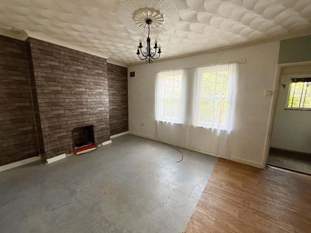 Living room with fireplace and windows to front