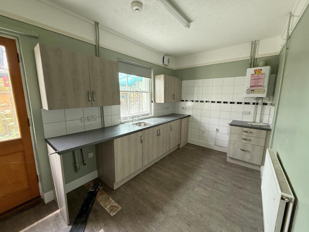 Kitchen with window and door to rear