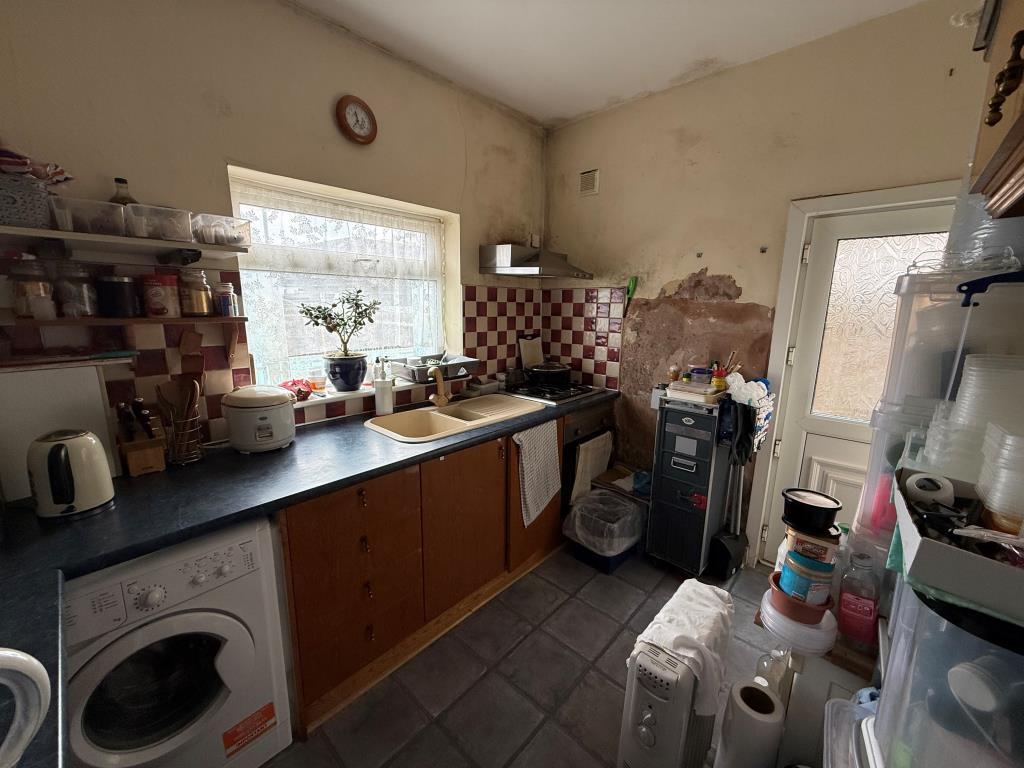 Kitchen showing back door with access to garden