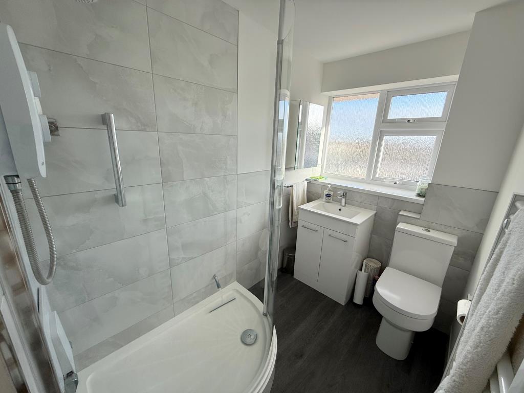 Bathroom with electric shower wc, basin and heated