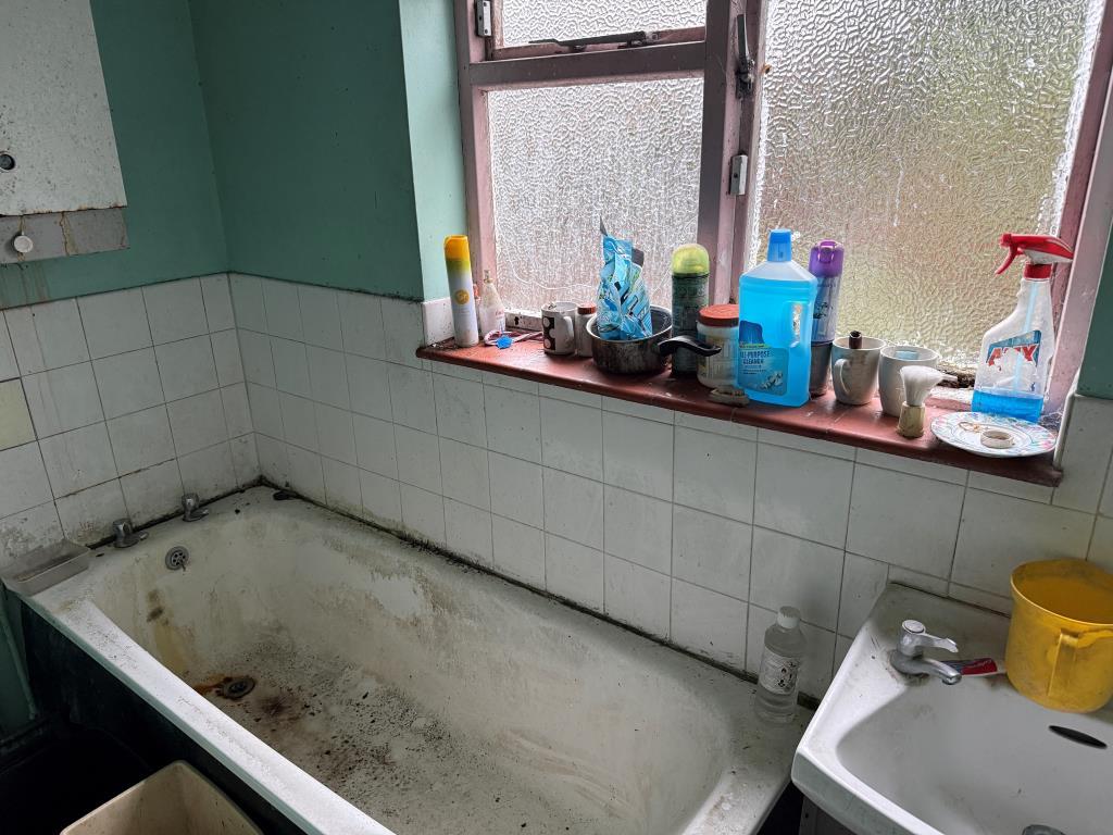 White bathroom and sink at rear of ground floor