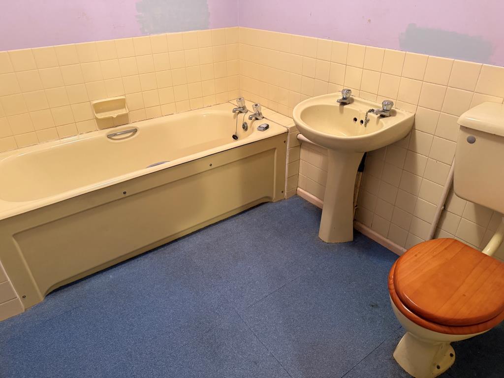 Yellow bathroom suite with sink and WC