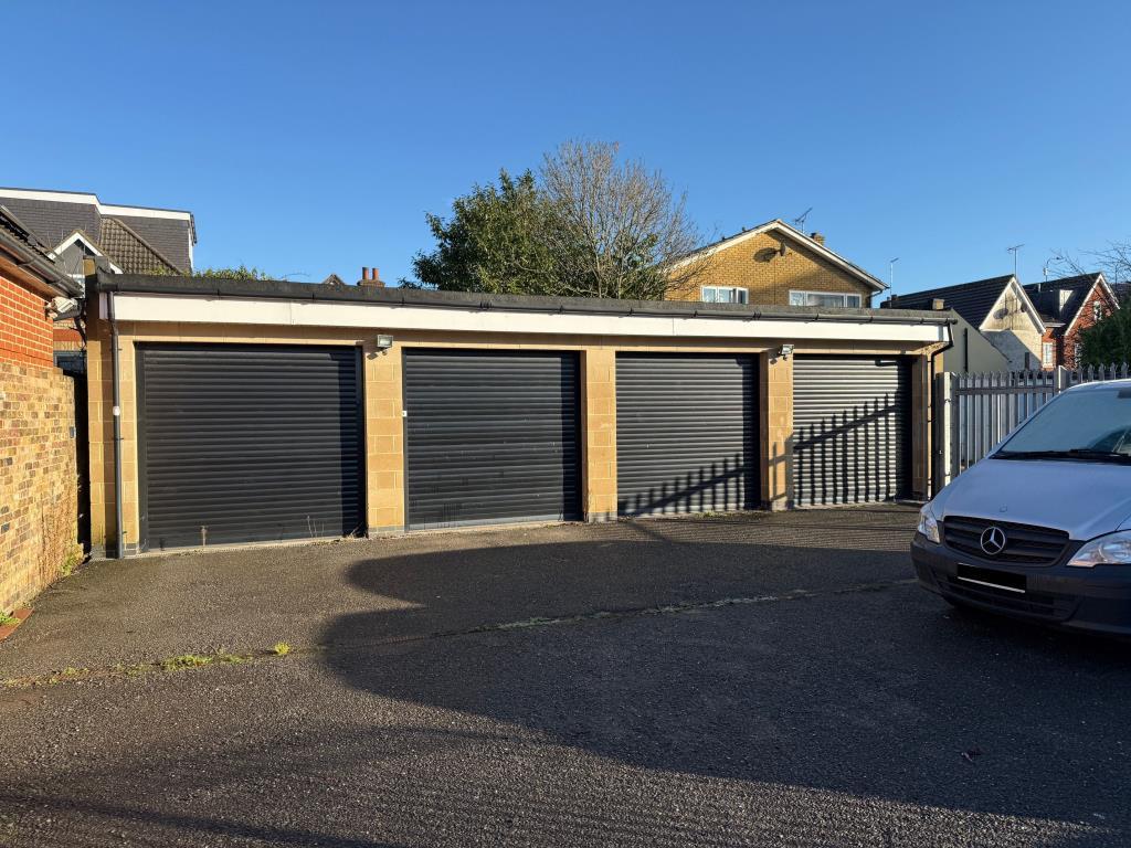 Four Garages with black roller shutter fronts