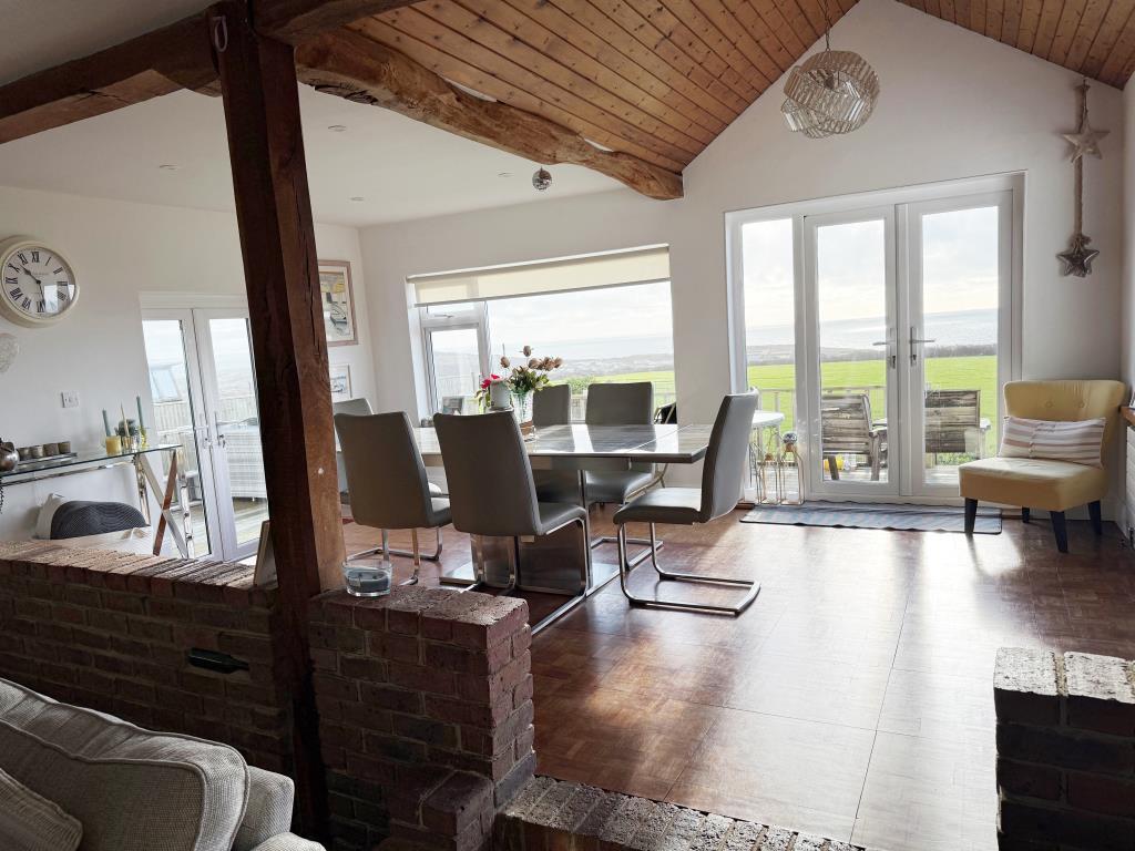 Living area with fireplace and wooden flooring