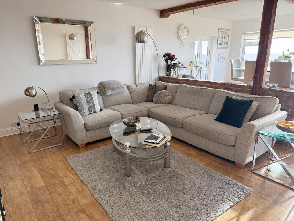 Raised dining area with views and doors to garden