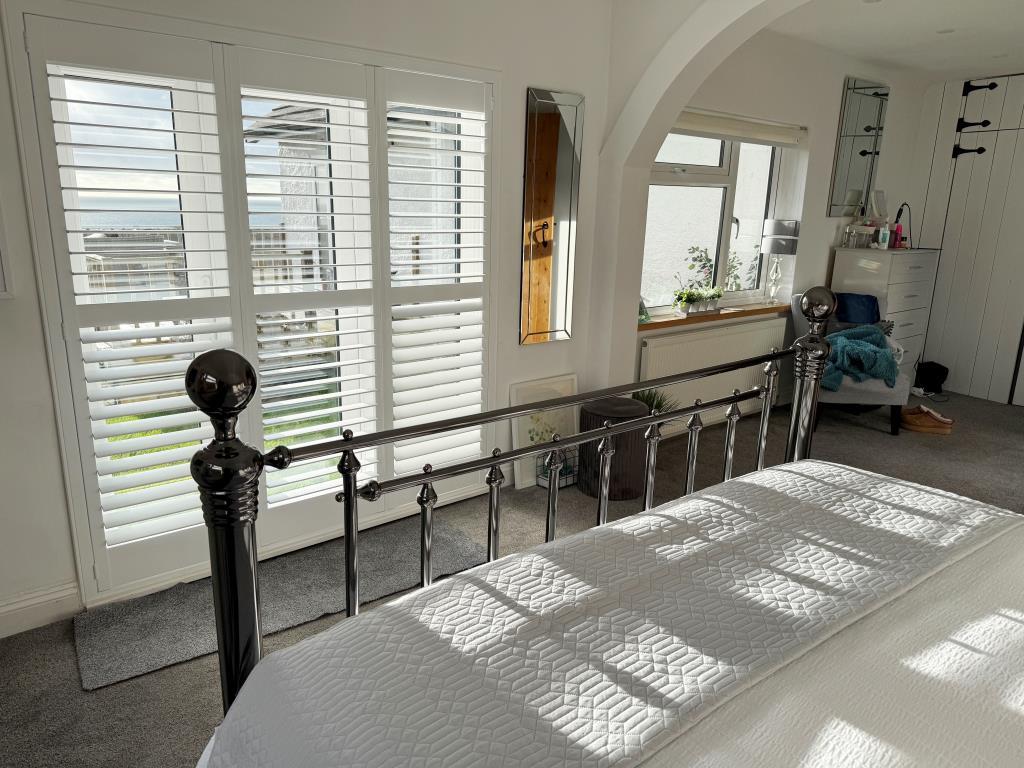 Main bedroom with views and doors to decking