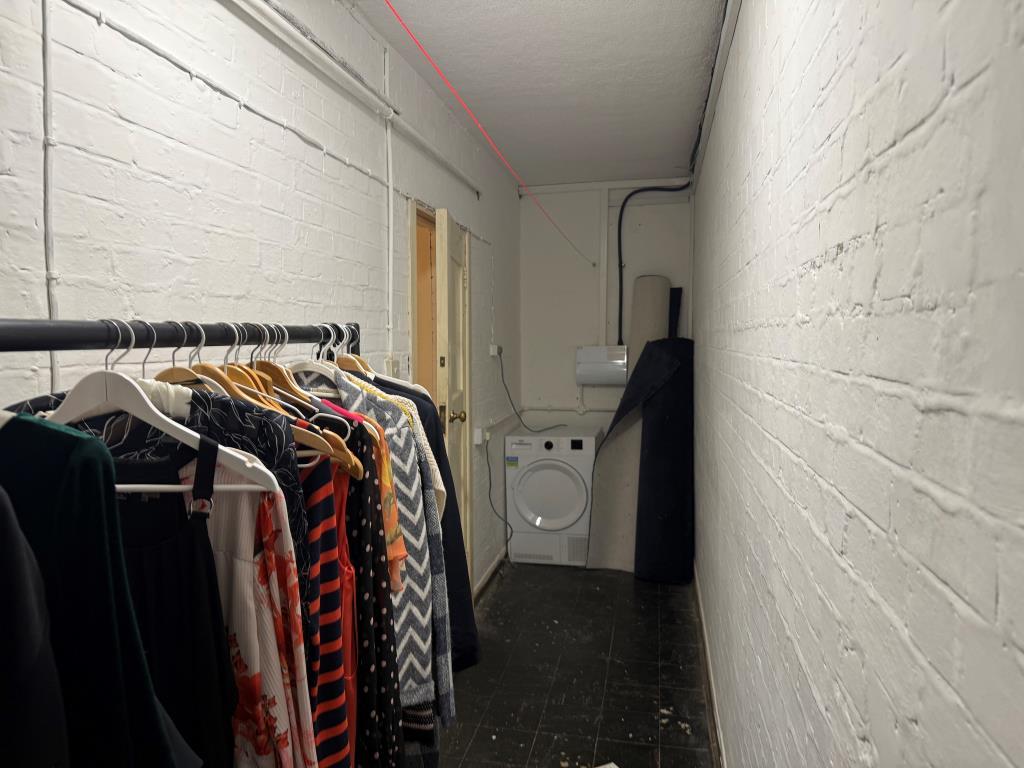 Storage cupboard showing washer and further space