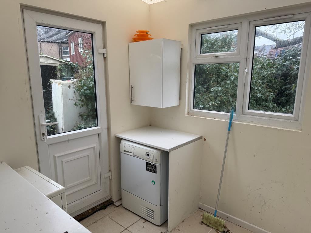 Utility room with window and door to garden