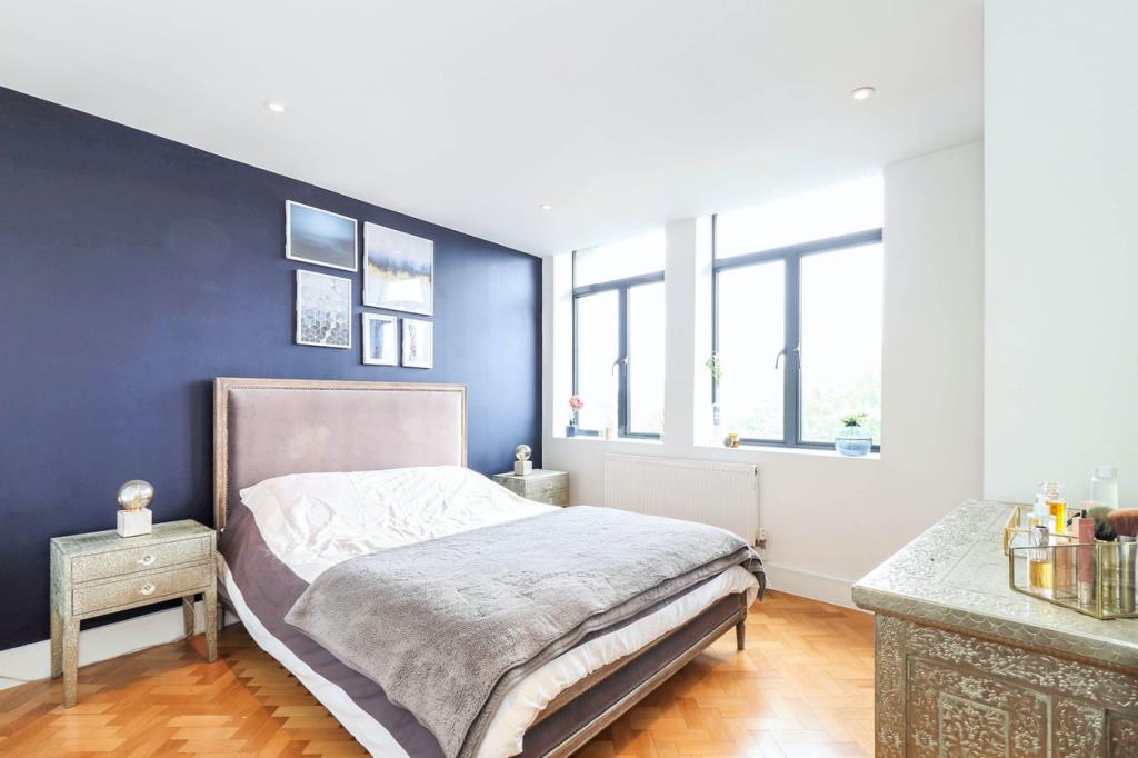 Bedroom One with windows to front and wooden floor